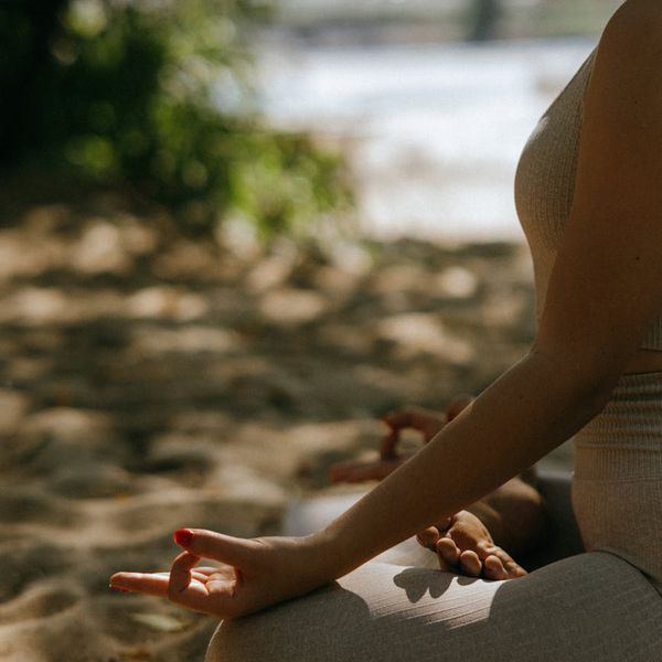 Person meditating calmly in a serene environment.